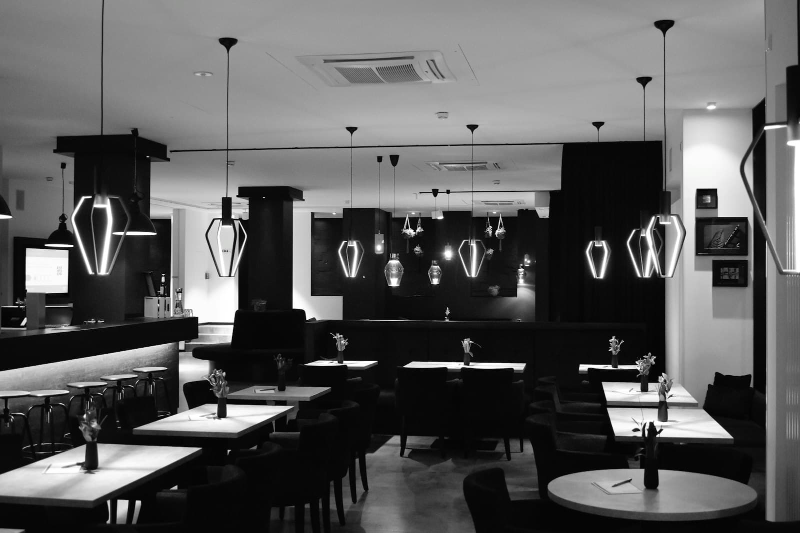 A restaurant dining room with pendant lights