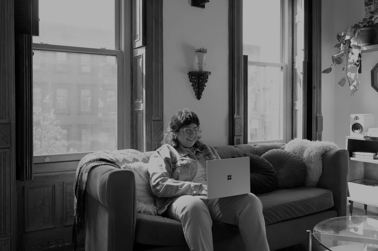 Someone working on a laptop on the sofa