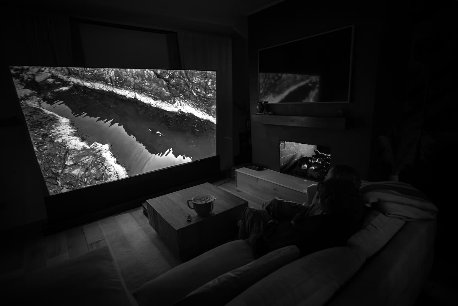 A large screen in a dark living room