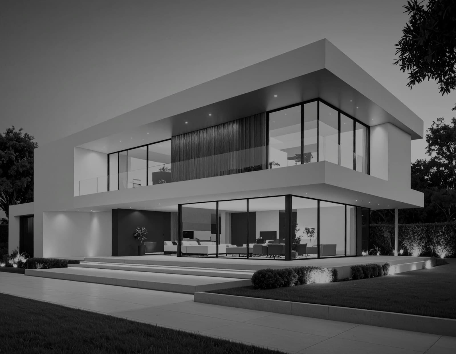 A modern house lit up at dusk