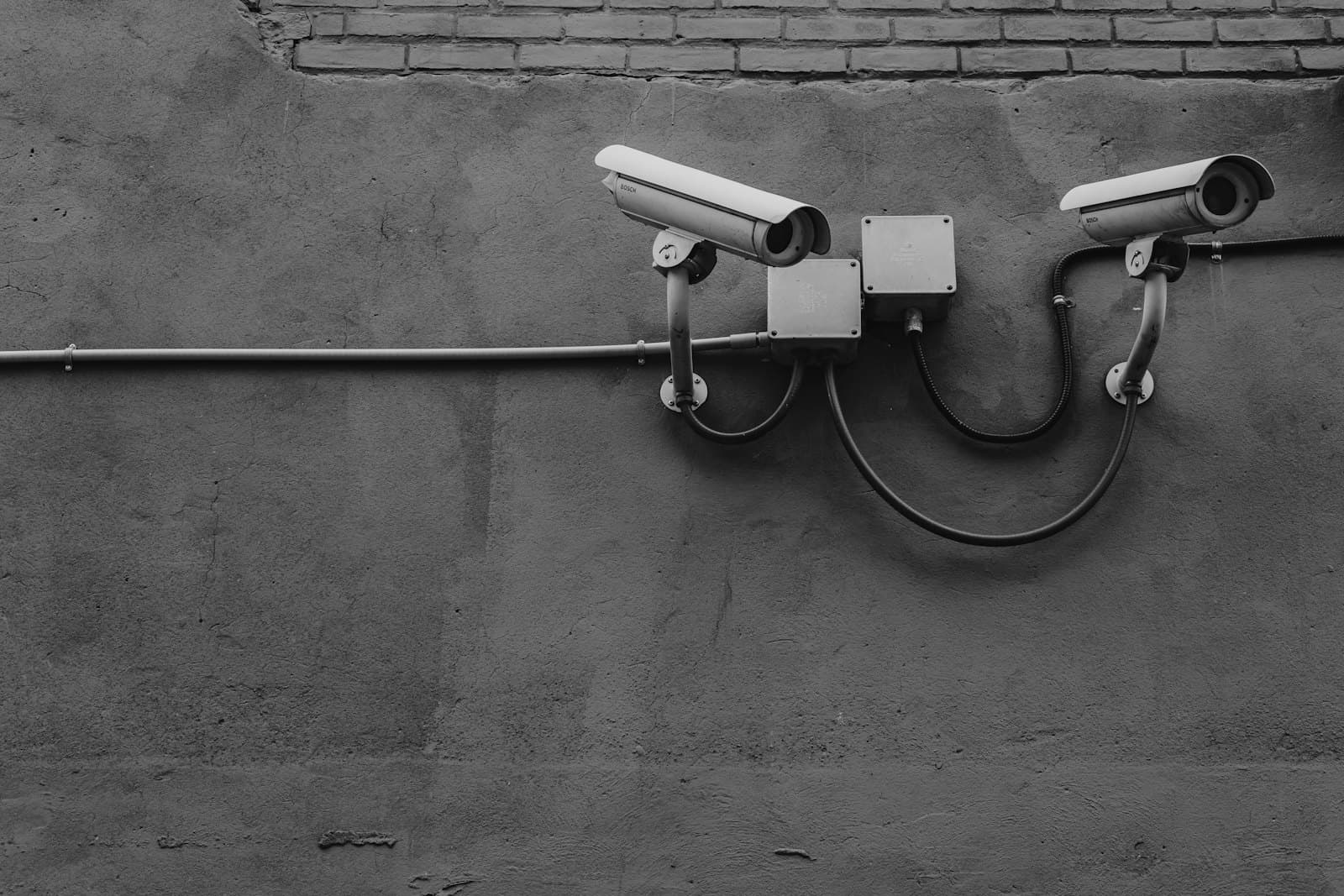 Two security cameras mounted on a wall