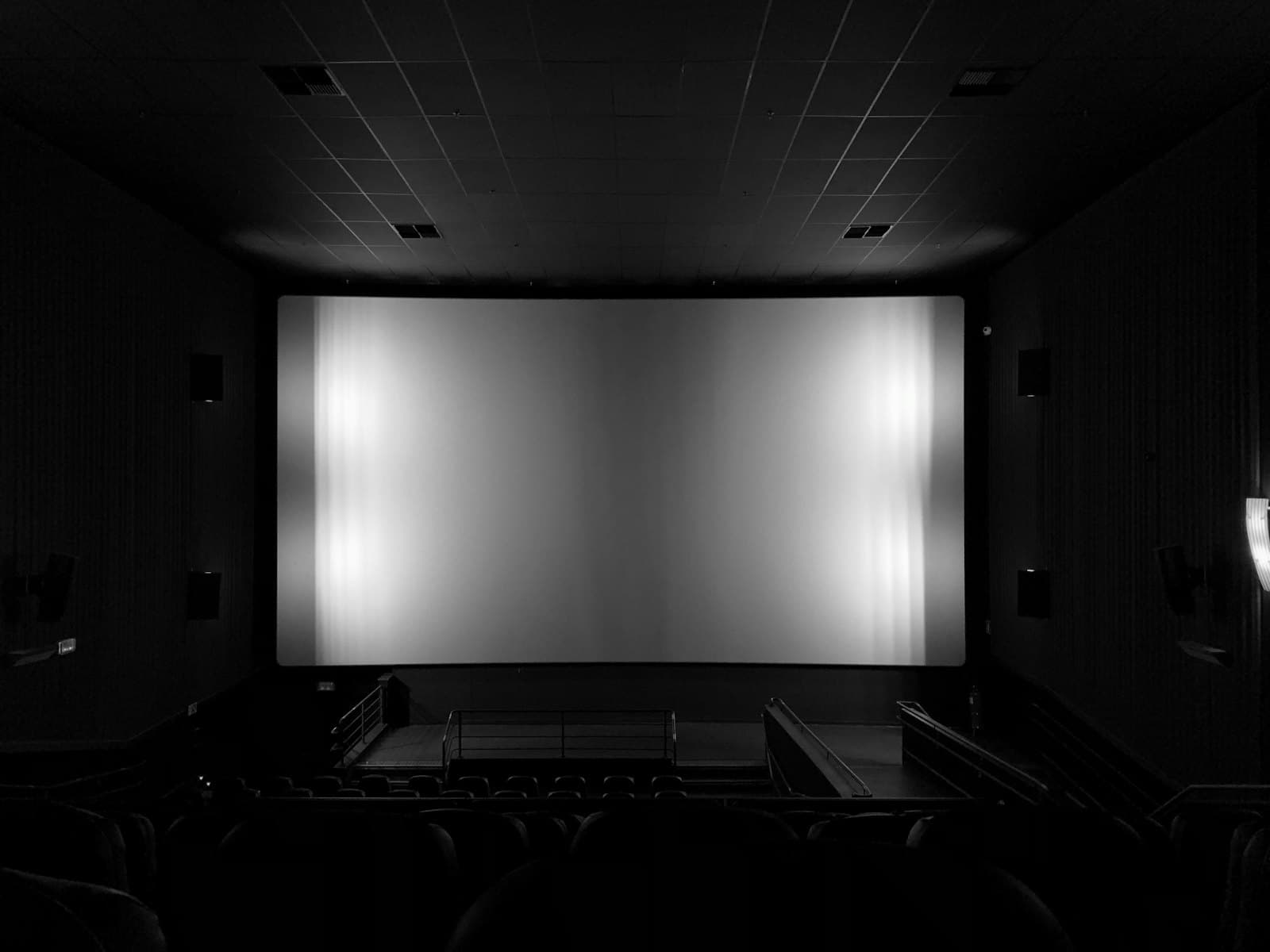 A dark home cinema with a large screen