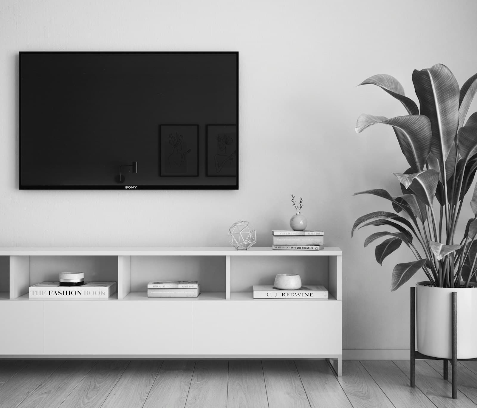 A wall-mounted television above a media console